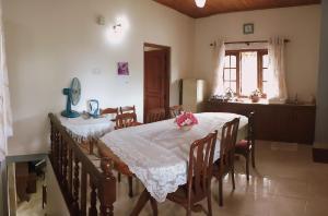 a dining room with a table and a kitchen at Staykandy in Kandy