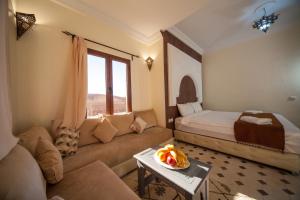 a living room with a couch and a bed at Ksar Sultan Dades in Boumalne Dades