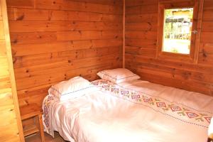 A bed or beds in a room at Camping Abadesses