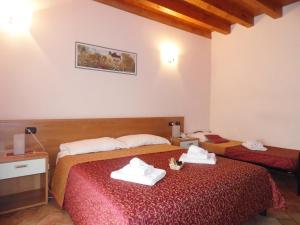 Postel nebo postele na pokoji v ubytování Hotel Agli Ulivi