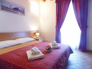 Postel nebo postele na pokoji v ubytování Hotel Agli Ulivi