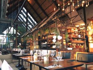 a restaurant with tables and chairs with wine glasses at Baan Peang Ploen B411 in Hua Hin