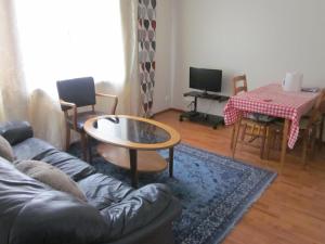a living room with a couch and a table at Karijoen Helmi in Karijoki