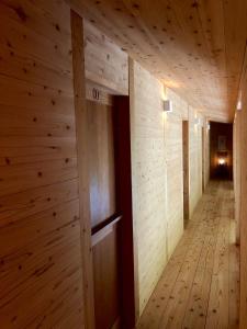 a hallway in a wooden building with wooden walls at Kaiza in Nanjo