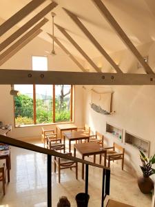 a room with wooden tables and chairs and a large window at Kaiza in Nanjo +37 photos