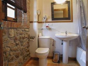 a bathroom with a toilet and a sink at Hospederia Santillana in Santillana del Mar