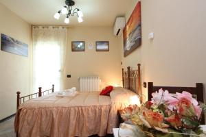 Postel nebo postele na pokoji v ubytování Da Donna Rosa + 10 fotografií