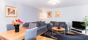a living room with a couch and a table at Lets Holiday In London Greenwich in London
