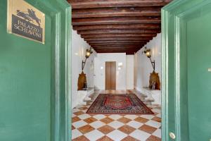 a hallway with a wooden ceiling and a tile floor at Palazzo Schiavoni Suite-Apartments in Venice