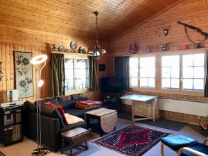 a living room with a couch and a table at Ferienwohnung im Chalet Firn - OG in Bürchen