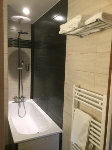 a bathroom with a white sink and black walls at Le Clos De Mutigny in La Chaussée-sur-Marne +63 photos