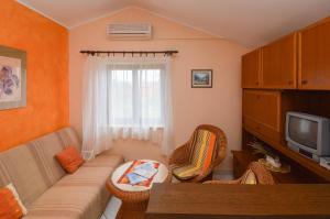 a living room with a couch and a tv at Lavanda Vacation Home. in Medulin