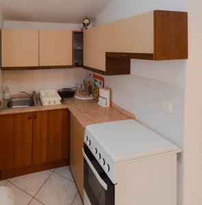 a kitchen with a white stove and a sink at Lavanda Vacation Home. in Medulin