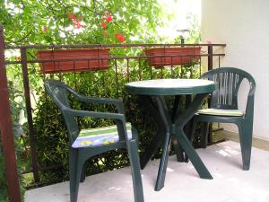 two chairs and a table and a table and two chairs at Lavanda Vacation Home. in Medulin