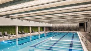 a large swimming pool with blue water at The Hotel & Athletic Club at Midtown in Chicago