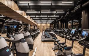 a gym with rows of exercise bikes and treadmills at The Hotel & Athletic Club at Midtown in Chicago