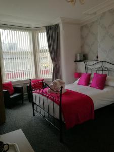a bedroom with a bed with a dog laying on it at Birchhouse in Blackpool