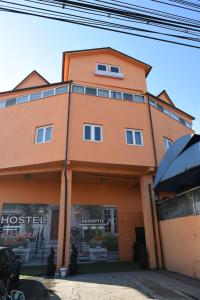 a large orange building with a store front at Hostel Ruxandra in Focşani