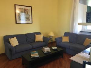 a living room with a blue couch and a coffee table at Finestra su Genova - free parking in Genoa