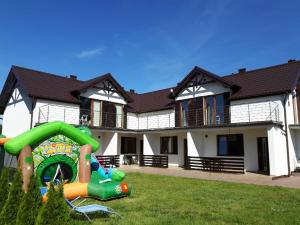 a house with a playground in front of it at RESORT Riva & Avir in Jastrzębia Góra