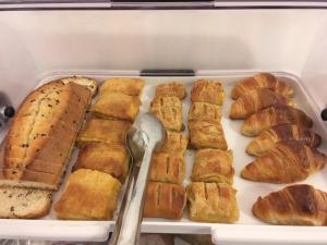 a plastic container filled with pastries and croissants at Irigeneia Hotel in Perissa