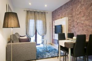 a living room with a couch and a table at Aparthotel Rambla108 in Barcelona