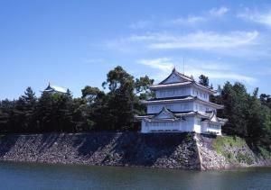 a large white building on the side of a body of water at APA Hotel Nagoya Sakae Ekimae EXCELLENT in Nagoya