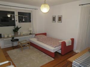 a small bedroom with a bed and a window at Marigold in Neumünster