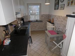 a kitchen with a sink and a table in it at Marigold in Neumünster
