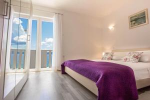 Postel nebo postele na pokoji v ubytování Apartments Perla