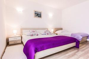 Postel nebo postele na pokoji v ubytování Apartments Perla