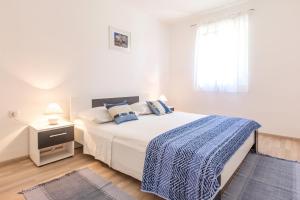 Postel nebo postele na pokoji v ubytování Apartments Perla
