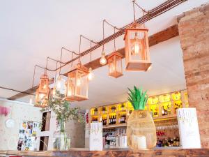 a bar with several lights hanging from the ceiling at Casa de la Catedral in Granada