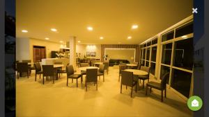 a restaurant with tables and chairs in a room at Vog Torres do Sul in Ilhéus