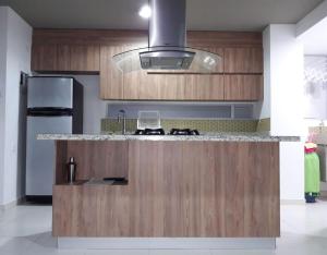 a kitchen with a wooden counter top and a stove at Casa de verano in San Jerónimo