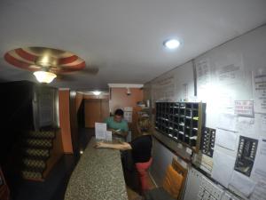 a woman standing at a counter in a fast food restaurant at Hotel Villa del Mar in Panama City