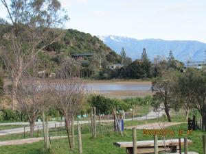 a park with a bench next to a lake at Woolshed Bed & Breakfast in Takaka