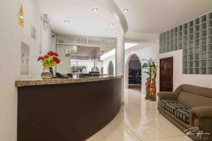 a lobby with a bar with a couch in a room at Hotel Costa Andina in Moche