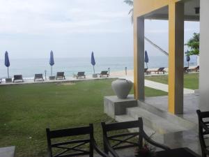 a patio with chairs and a view of the ocean at Amanda Beach Villas in Unawatuna