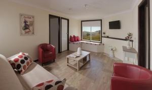 a living room with a couch and a table and chairs at Wantana Cottage Farmstay in Boorowa