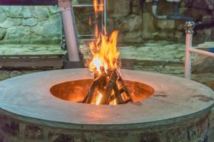 a large fire pit with flames in it at Tea Hills Bungalow in Hatton