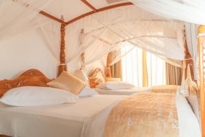 a bedroom with two beds with white sheets and curtains at Tea Hills Bungalow in Hatton
