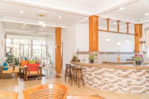 a restaurant with a bar with chairs and tables at Tea Hills Bungalow in Hatton