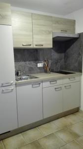 a kitchen with white cabinets and a sink at Temelerhof in Gries im Sellrain