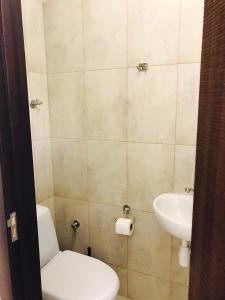 a bathroom with a toilet and a sink at Квартира in Kyiv