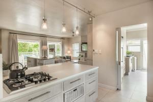 a kitchen with a stove and a counter top at Riverclub Villa 4200 in Plettenberg Bay