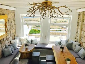 a living room with a couch and a table at Milo Milo Suites in Mandrakia