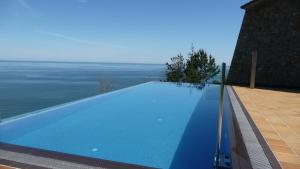 a large swimming pool on the side of a house at Agroturismo Itxaspe in Orio