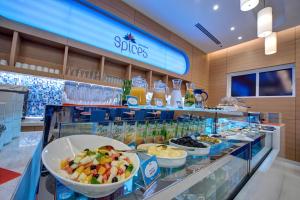 a buffet line with bowls of food in a store at Al Khoory Inn Bur Dubai in Dubai