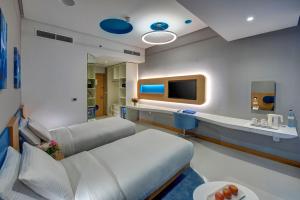 a hospital room with a couch and a tv at Al Khoory Inn Bur Dubai in Dubai